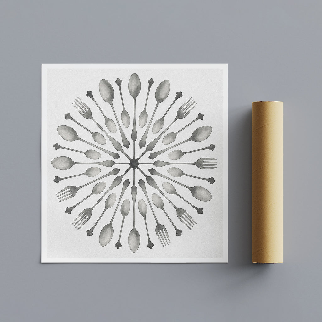 Decorative stencil with spoon and fork pattern on a white sheet, next to a cardboard roll on a gray background.