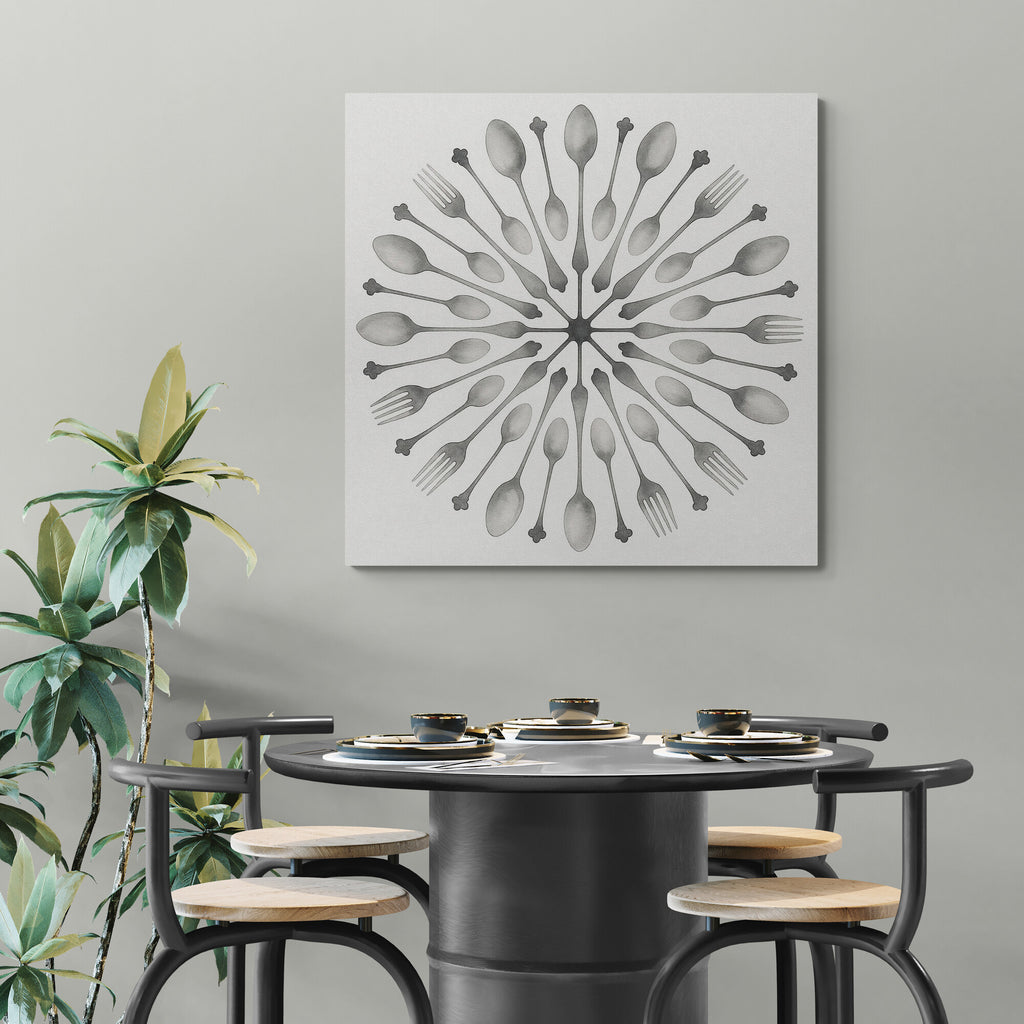 Dining area with a black round table and stools, featuring a wall art piece with a geometric design of spoons and forks.