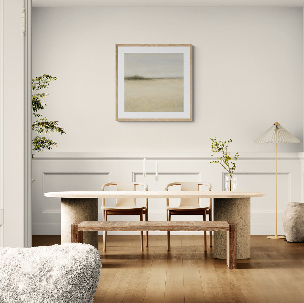 Modern dining room with a table, chairs, and a bench against a white wall with a framed picture.