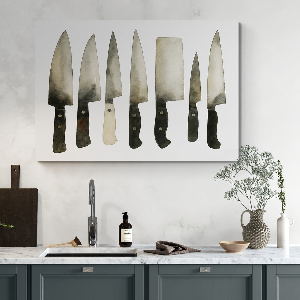 Kitchen scene with a wall art of knives above a sink.